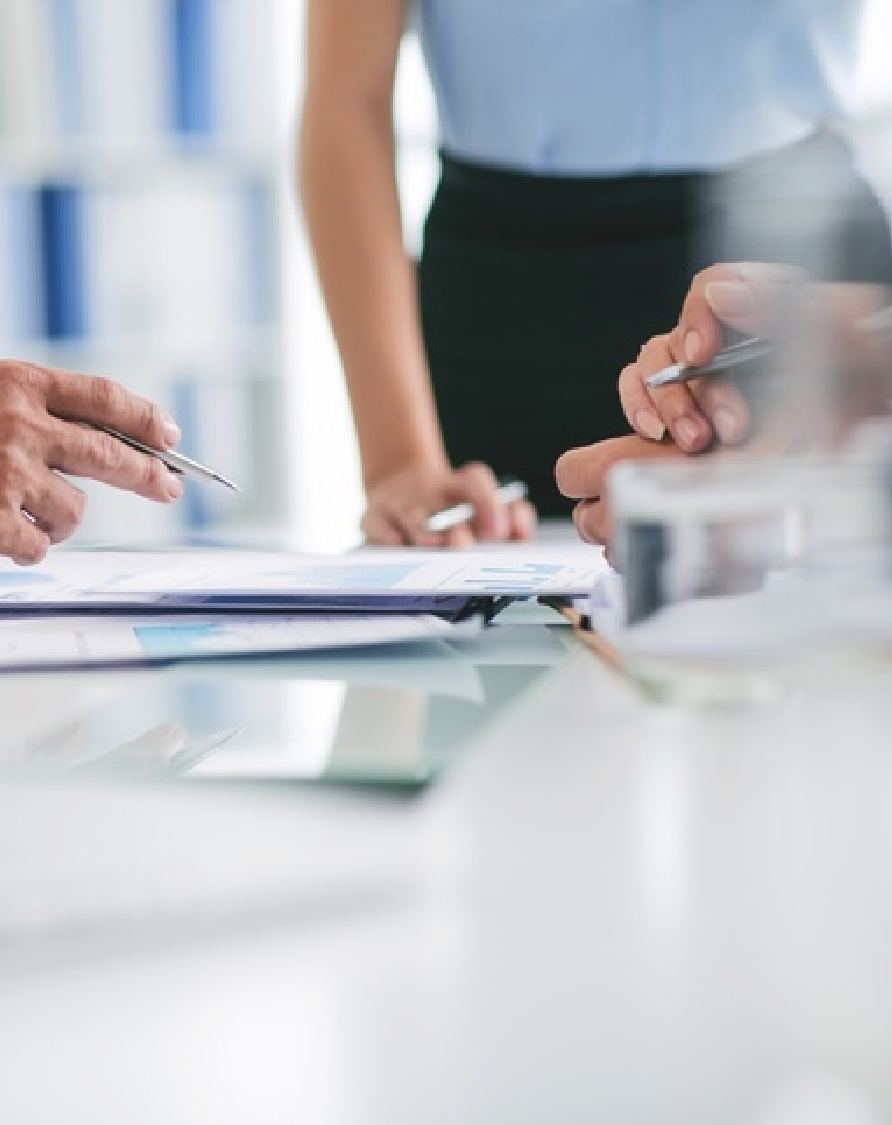 Image of busy hands working on a work table representing how people can focus on business continuity through cloud solutions despite disaster and emergency.